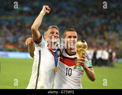 Lukas Podolski of Germany celebrates with the trophy