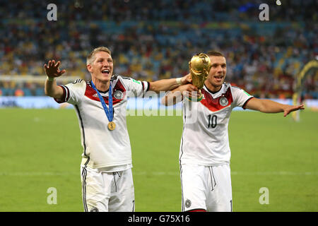 Soccer - FIFA World Cup 2014 - Final - Germany v Argentina - Estadio do Maracana. Germany's Bastian Schweinsteiger and Lukas Podolski (right) celebrate with the World Cup trophy Stock Photo