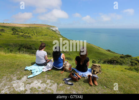 A group of women enjoy the view across the channel from the White Cliffs of Dover in Kent, as temperatures are set to soar, health officials have urged people to take care in the summer heat. Stock Photo