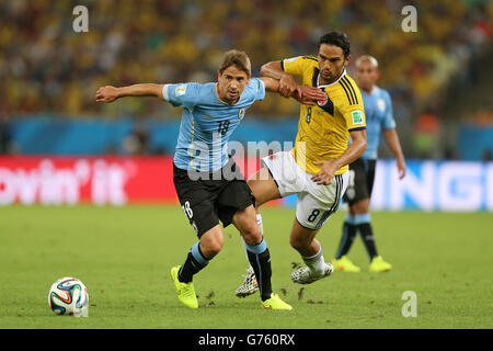 Colombia's Abel Aguilar (right) and Uruguay's Gaston Ramirez battle for the ball during the FIFA World Cup, Round of 16 match at the Estadio do Maracana, Rio de Janeiro, Brazil. Stock Photo