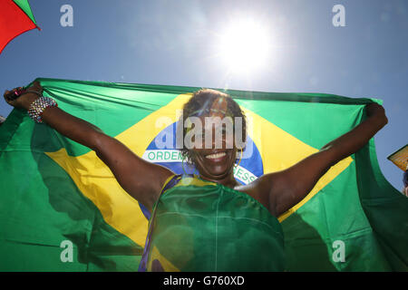 Brazil fans celebrate their team's victory in a penalty shoot-out over Chile as they watch in a fan park in Recife Stock Photo