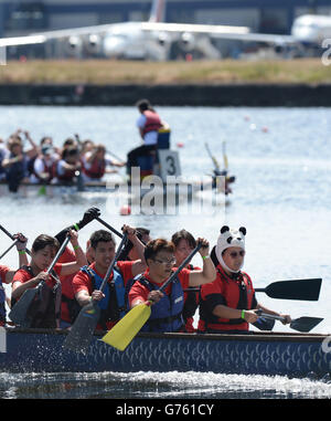 Competitors participate in this year's London Hong Kong Boat Festival in which dragon boats compete for four trophies on Royal Albert Dock in east London. Stock Photo