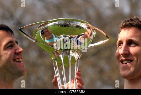 Thomas Stallard (left) president of the Cambridge University boat race team and Benjamin Burch (right) president of the Oxford University boat race team with the Boat Race trophy at the weigh-in in Fulham, London, ahead of the annual race between the two University's on Saturday on the River Thames. Stock Photo