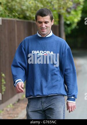 Republic of Ireland and Manchester United's Roy Keane walks his dog outside his home in Hale Barnes, Cheshire. Keane was sent home last week by manager Mick McCarthy after a clear-the-air meeting with the Manchester United skipper had turned into a slanging match. * But Keane said yesterday he wanted to return and McCarthy had left the door open for the midfielder to apologise, which could have left a route back into the squad. Stock Photo