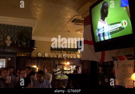 Football Fans at the Blue Posts public house, London, look on as Senegal and France leave the pitch at half-time, with the African nation having scored the first goal of the 2002 World Cup finals against the World Champions. * Senegal went on to surprise the champions by winning 1-0. The finals, hosted by Japan and South Korea, began today and will finish on June 30. Stock Photo