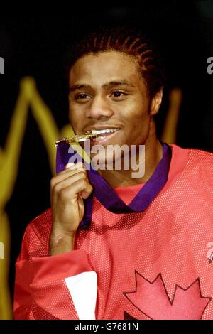 Canada's Jean Pascal bites his gold medal after beating England's Paul Smith in the 71kg Light-Middleweight final in the Commonwealth Games, at Manchester Evening News Arena. Stock Photo