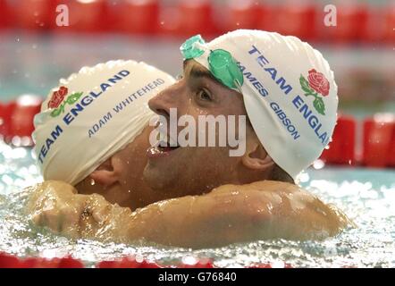 England's James Gibson hugs Adam Whithead (who got silver) after winning gold in the men's 50m Breaststroke Finals at the 2002 Commonwealth Games, Manchester Aquatic Centre, Manchester. Stock Photo