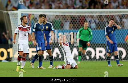 Soccer - FIFA World Cup 2014 - Final - Germany v Argentina - Estadio do Maracana. Germany's Philipp Lahm (centre) and Mario Gotze celebrate the win after the final whistle. Stock Photo