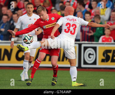 Cliftonville's Chris Curran (centre) and Debrecen's Jozsef Varga in action during the UEFA Champions League Qualifying match at Solitude, Belfast. Stock Photo