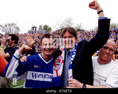 Reading's goalscorer Jamie Cureton (L) celebrates promotion with owner & chairman John Madejski (right) after Reading's 1-1 draw with Brentford in the Nationwide League Division Two match at Brentford's Griffin Park stadium. .