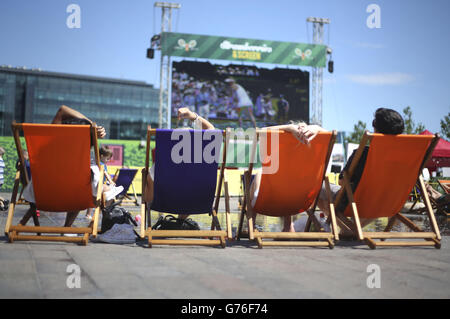 Summer Weather - Wimbledon tennis - Granary Square, London. People watching Wimbledon tennis on a big screen in Granary Square at King's Cross in central London. Stock Photo