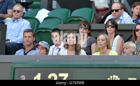 Andriy Shevchenko (left) in the players box with his wife Kristen Pazik (yellow top) during day twelve of the Wimbledon Championships at the All England Lawn Tennis and Croquet Club, Wimbledon. Stock Photo
