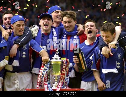 Ranger's (left to right) Allan McGregor, Ronald de Boer, Shota Arveladze, Tore Andre Flo, Stefan Klos, Barry Ferguson, Neil McCann celebrate winning the Tennent's Scottish Cup final match between Celtic and Rangers at Hampden Park, Glasgow Rangers defeated Celtic 3-2. *12/05/02Ranger's (left to right) Allan McGregor, Ronald de Boer, Shota Arveladze, Tore Andre Flo, Stefan Klos, Barry Ferguson, Neil McCann celebrate winning the Tennent's Scottish Cup final match between Celtic and Rangers at Hampden Park, Glasgow Rangers defeated Celtic 3-2. Celtic and Rangers will be invited to join the Stock Photo