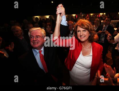 New leader of the Irish Labour party Joan Burton is congratulated by former leader Eamon Gilmore at the Mansion House in Dublin following the count for the leadership elections. Stock Photo