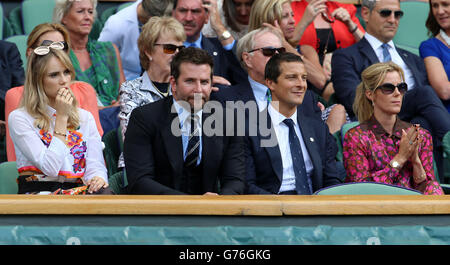 (left to right) Suki Waterhouse, Bradley Cooper, Bear Grylls and his wife Shara in the Royal Box on Centre Court during day twelve of the Wimbledon Championships at the All England Lawn Tennis and Croquet Club, Wimbledon. Stock Photo