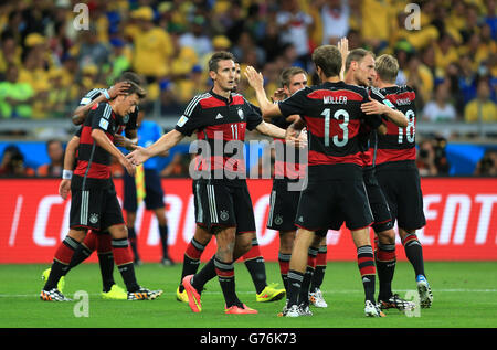 Germany's Miroslav Klose (left) celebrates scoring his side's second goal of the game with teammates during the FIFA World Cup Semi Final at Estadio Mineirao, Belo Horizonte, Brazil. Stock Photo