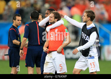 Netherlands' Daley Blind (centre) in tears as he is consoled by team-mates following their loss in the penalty shoot-out during the FIFA World Cup Semi Final at the Arena de Sao Paulo, Sao Paulo, Brazil. PRESS ASSOCIATION Photo. Picture date: Wednesday July 9, 2014. See PA story SOCCER Holland. Photo credit should read: Mike Egerton/PA Wire. RESTRICTIONS: Editorial use only. No commercial use. No use with any unofficial 3rd party logos. No manipulation of images. No video emulation Stock Photo