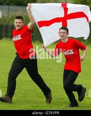 Simon Davies (left) and Jack Sherlock, from Wallasey on the Wirrall celebrate after winning a competition, sponsored by Coca-Cola to be part of the six strong team who will carry the England flag out at the start of their opening World Cup match against Sweden in Japan. Stock Photo