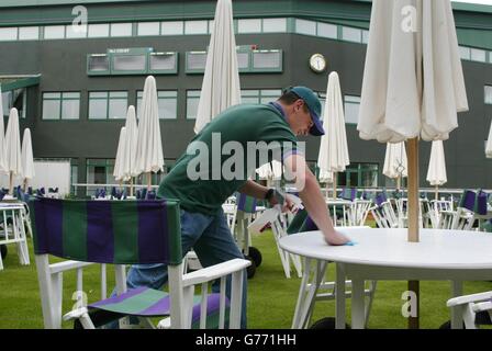 teve Barnes of the Members Team Support makes sure the Members Enclosure is spotless before the opening matches of The Championships at The All England Lawn Tennis Club in south west London. Stock Photo