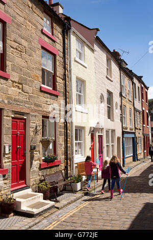 UK, England, Yorkshire, Staithes, High Street, children on cobbles Stock Photo