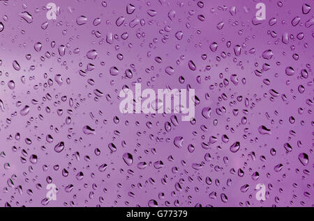 Water droplets on the glass with a colored background. Drops of water. Stock Photo