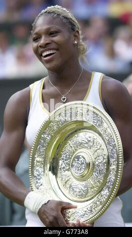 , NO COMMERCIAL USE. Serena Williams from the USA holds her trophy after beating her sister Venus in the Ladies' Singles Final at Wimbledon. It is the first time in 118 years that sisters have met in the final at Wimbledon. Serena triumphed in straight sets 7:6/6:3. Stock Photo