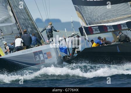 Britain's America's Cup team GBR Challenge (right) tack across the Swedish Victory Challenge yacht in the Hauraki Gulf off Auckland, New Zealand. *...Wight Lightning sped away from the start after forcing the Swedes across the line before the gun making the black boat complete a 360 degree penalty turn. GBR maintained the lead and came home victors by 48 seconds. It gives the team their second win in the first round of the Louis Vuitton Cup, suprising many. Stock Photo