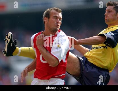 Arsenal's Fredrik Ljungberg avoids the boot of Bolton Wanderers' Anthony Barness during their FA Barclaycard Premiership match at Arsenal's Highbury stadium in London. Stock Photo