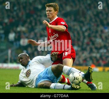 Liverpool's John Arne Riise (right) challenges Aston Villa's Dion Dublin for the ball during their Barclaycard Premiership match at Liverpool's Anfield stadium. Stock Photo