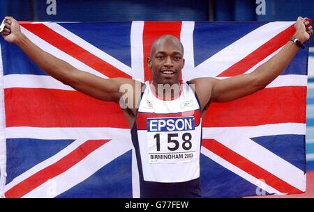 Great Britain's Marlon Devonish holds up the British flag after winning gold in the final of the men's 200m at the 9th World Indoor Championship at the NIA, Birmingham. Stock Photo