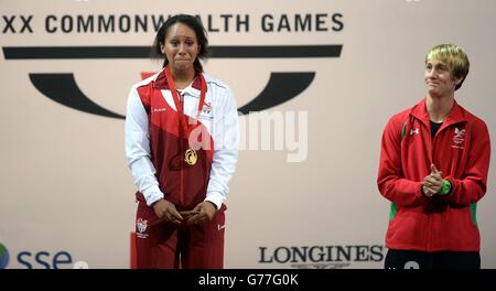 England's Zoe Smith with her gold medal after winning the womens 58kg weightlifting with Wales' Michaela Breeze (right), at the Clyde Auditorium during the 2014 Commonwealth Games in Glasgow. Stock Photo