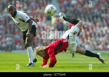 Manchester United's David Beckham falls over from a challenge from Fulham's Luis Boa Morte (left) during the Barclaycard Premiership match at Old Trafford, Manchester. Stock Photo