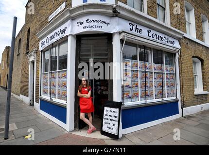 Textile artist Lucy Sparrow stands in the doorway of her art installation, The Cornershop in Wellington Row, Bethnal Green, east London, where nearly 2,000 classic groceries inside are handmade from felt and are for sale as an art work. Stock Photo