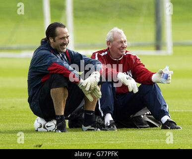 Arsenal goalkeeper David Seaman (left) smiles as he talks with goalkeeper coach Bob Wilson during a training session at Arsenal's training ground, London Colney, Hertfordshire. Arsenal will play Auxerre in their Champions League Group A match. Stock Photo