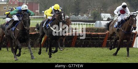 Korelo with jockey Tony McCoy (left) wins ahead of Lawz (centre) and Mercato (right) in The Sunderlands Imperial Cup Hurdle Race at Sandown Park. Stock Photo