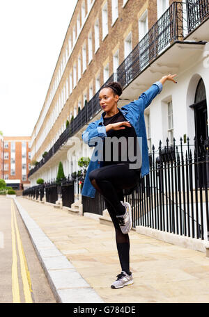 young woman dancing in the street Stock Photo