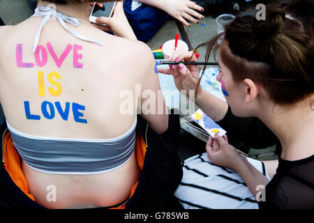 Pride In London Trafalgar Square A Woman With Rainbow Body Paint And Bikini Top Saying