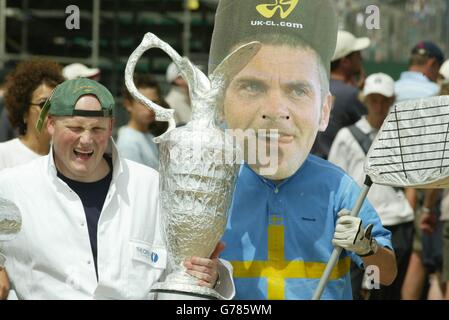 Steve Vize from Manchester (left) with a friend wearing a mask of Sweden's Jesper Parnevik, during the last round of the 132nd Open Championship at Royal St George's, Sandwich, Kent. Stock Photo