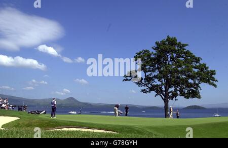 South African Ernie Els makes a putt on the sixth green with his playing partner Darren Clarke looking on during the final round of the Barclays Scottish Open at Loch Lomond golf club near Balloch. Stock Photo