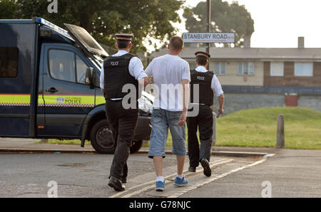 A suspect is led away as City of London Police execute a warrant at an address in Peckham, London, in connection with a criminal ring linking Russian hackers and ID thieves with ticket resellers in New York and money-launderers in the United Kingdom and Canada. Stock Photo