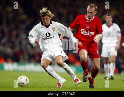 Manchester United's David Beckham (left) tries to get away from Liverpool's Danny Murphy during the Worthington Cup Final at the Millennium Stadium, Cardiff. Stock Photo