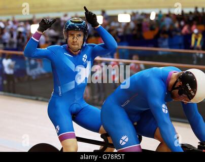 Scotland's Neil Fachie (left)and pilot Craig MacLean celebrate winning Gold with Craig Maclean in the Para Sport 1000m Time Trial B Tandem at the Sir Chris Hoy Velodrome during the 2014 Commonwealth Games in Glasgow. Stock Photo