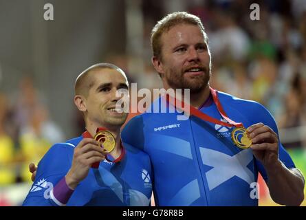 Scotland's Neil Fachie (left) and Craig MacLean celebrate with their gold medals after winning the Men's Para-Sport 1000m Time Trial B Tandem Final at the Sir Chris Hoy Velodrome during the 2014 Commonwealth Games in Glasgow. Stock Photo