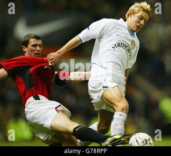 Manchester United's Roy Keane (left) challenges Alan Smith of Leeds United, during their Barclaycard Premier League match at Old Trafford, Manchester. Stock Photo