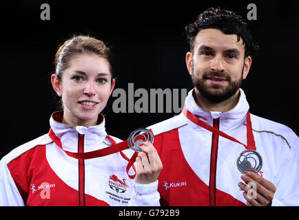 England's Heather Oliver and Chris Langridge with their silver medals after losing their gold medal match to Gabrielle and Chris Adcock at the Emirates Arena, during the 2014 Commonwealth Games in Glasgow. Stock Photo