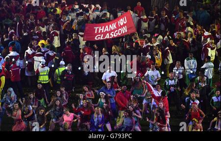 Performers and athletes dance during the 2014 Commonwealth Games Closing Ceremony at Hampden Park, Glasgow. Stock Photo