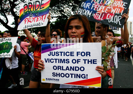 Philippines. 25th June, 2016. A poster calling for justice for the victims in the recent shooting in Orlando is held by a LGBTQ member at the Luneta Park. LGBTQ community members participate in the 22nd Gay Pride March in Manila. The march was participated by thousands of LGBTQ members who walked in solidarity with this year's theme, Let Love In. Credit:  J Gerard Seguia/ZUMA Wire/Alamy Live News Stock Photo