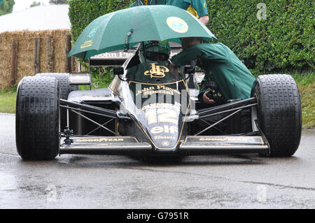 Ayrton Senna Lotus 98 Formula 1 Grand Prix racing car at Goodwood Festival of Speed 2016. Historic F1 race car. Raining. Umbrella over driver and crew Stock Photo