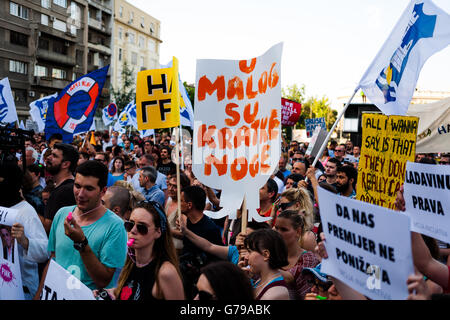 Belgrade, Serbia. 25th June, 2016. Demonstrators with banners front of National Assembly in Belgrade. They are blowing in the whistle, waving the flags and shouting. Milos Bojovic/Alamy Live News Stock Photo