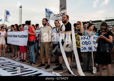 Belgrade, Serbia. 25th June, 2016. Demonstrators in front of Palace of Serbia. One of demonstrators is wrapped in toilet paper. Toilet paper is symbol of stinking acts of Serbian politicians. Milos Bojovic/Alamy Live News Stock Photo